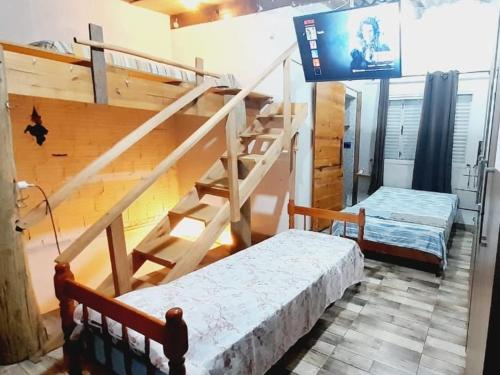 a room with two bunk beds and a staircase at Habitacion - Tercio in São Gabriel