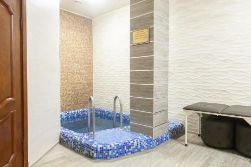 a jacuzzi tub in the corner of a room at Boutique Hotel Tomiris in Astana