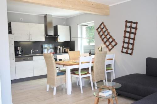 a kitchen and dining room with a table and chairs at Ferienhaus Skanhuus in Klütz
