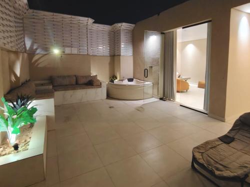 a large bathroom with a tub and a large room at NOVA Homes in Medina