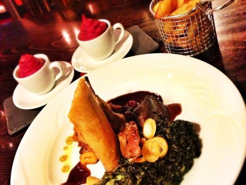 a white plate of food on a table with desserts at The Hand at Llanarmon in Llanarmon Dyffryn-Ceiriog