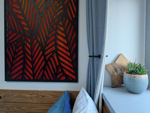a bedroom with a painting on the wall next to a bed at R3 - Cozy Small Double - City & Beach Access, WIFI, Free Parking, Bus Stop 50ft From House - Self Catering in Swansea