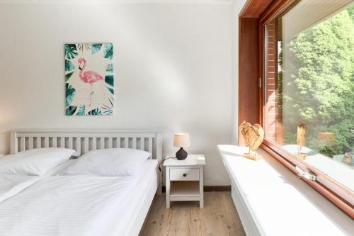 a bedroom with two beds and a window at Lund36 in Husum