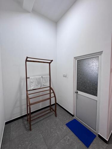 a room with a towel rack next to a door at Una Stay in Unawatuna
