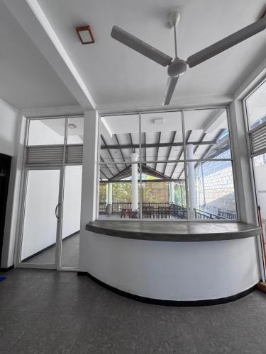 an empty room with a ceiling fan in a building at Una Stay in Unawatuna
