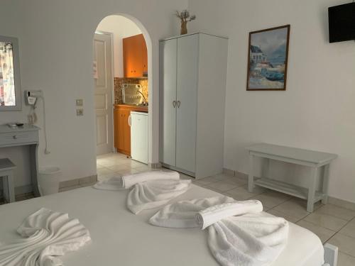 a bedroom with white towels on a bed at Melissa Rooms in Koufonisia