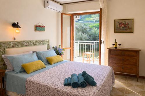 a bedroom with a bed with two pairs of shoes on it at Sea View Solarium- Free parking - 8 min beach - 3 min A14 - Mastrangelo Beach in Grottammare