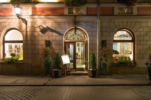 a store front of a building with arched windows at Hotel Polski Pod Białym Orłem in Kraków
