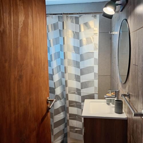 a bathroom with a sink and a mirror at Terramar cabañas in Mar del Plata