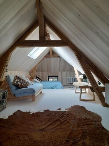 a attic room with a bed and a table at L'atypique du buisson de la gariole in Aubigny-sur-Nère
