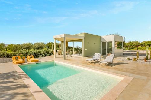 a swimming pool in front of a house at Fior di Noto in Noto