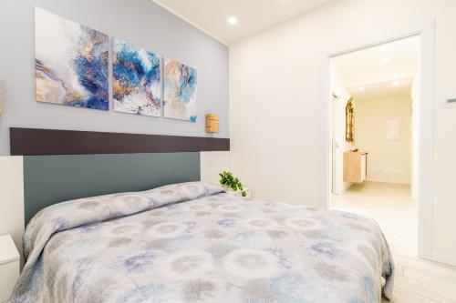 a bedroom with a large bed and a painting on the wall at Residenza Agave in Boario Terme