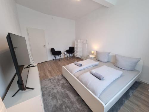 a white bed with two pillows on it in a room at Süße Marie 9 in Karlsruhe
