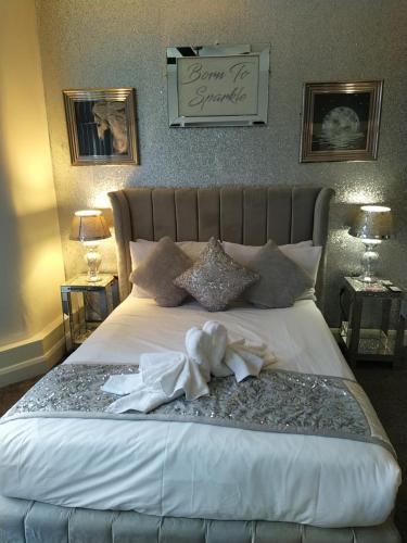 a bedroom with a large bed with white sheets at The Dreamcatcher Hotel in Blackpool