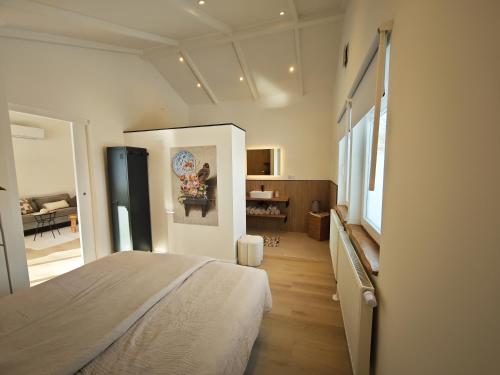 a bedroom with a bed and a living room at Vakantiewoning Hemme Limburg in Simpelveld