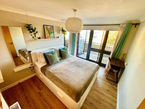 a bedroom with a bed and a large window at Bond Central - City Centre Oasis in Southampton