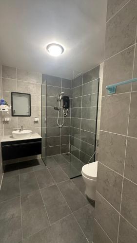 a bathroom with a shower and a toilet and a sink at Putrajaya Antara Residence, Near PICC, Presint 5 in Putrajaya