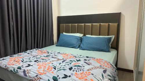 a bedroom with a bed with blue pillows at Putrajaya Antara Residence, Near PICC, Presint 5 in Putrajaya