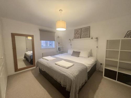 a bedroom with a bed with two towels on it at Warfield Charming Three Bedroom House in Warfield