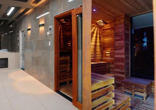 a sauna with wooden panels and a glass door at Entre Islas LODGE in Aquitania