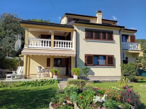 a villa with a view of the garden at Apartman Lori in Lovran