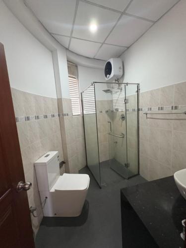 a bathroom with a shower and a toilet and a sink at Kandy krush Hotel in Kandy