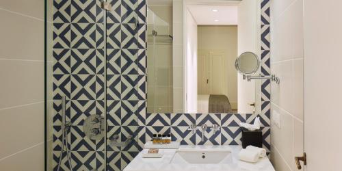 a bathroom with a sink and a mirror at The Lumiares Hotel & Spa - Small Luxury Hotels Of The World in Lisbon