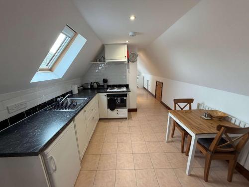 a kitchen with a sink and a table in it at Millbrook House Apartments 10 in Milton