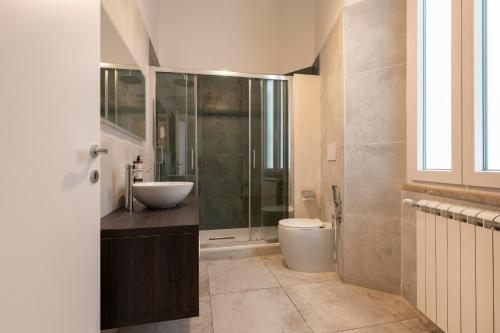 a bathroom with a sink and a shower and a toilet at Vittoriano Suite in Rome