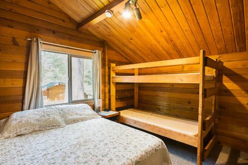 a bedroom with a bunk bed and a window at La Conner Camping Resort Cabin 7 in La Conner