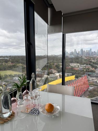 a table with glasses and a plate of oranges on it at Premium Apartment with 2 Beds 1 Bath in Melbourne