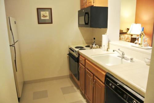 a kitchen with a sink and a stove at Cow Hollow Inn and Suites in San Francisco