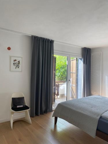 a bedroom with a bed and a sliding glass door at See- & Bergblick Millstatt in Millstatt