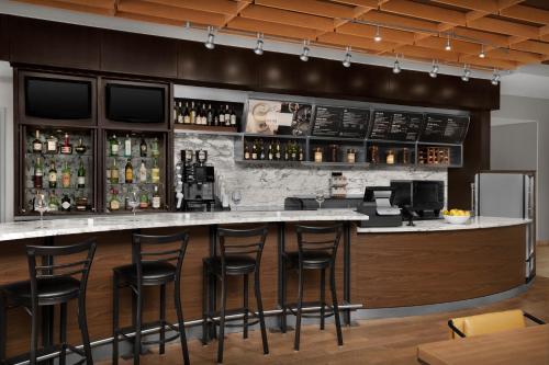 a bar in a restaurant with stools at Fairfield Inn and Suites Phoenix Chandler Fashion Center in Chandler