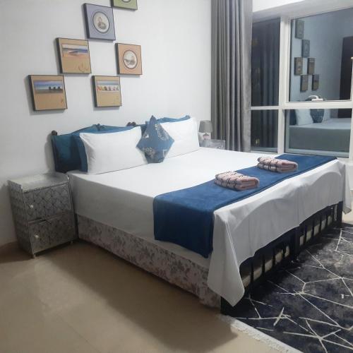 a bedroom with a large bed with two pillows on it at Private Room at Expo Centre Sharjah in Sharjah