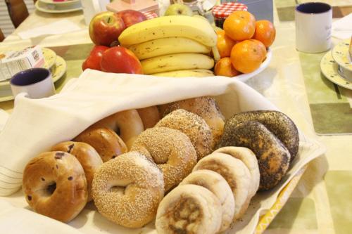 a box of different types of donuts on a table at The Coolidge Corner Guest House: A Brookline Bed and Breakfast in Brookline
