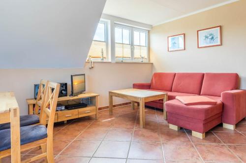 a living room with a couch and a tv at Ferienwohnung Katharina OG in Wohlenberg