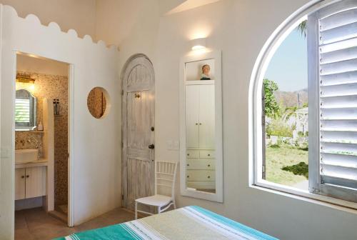 a bedroom with a bed and an arch window at Casablanca Escape in La Majahua