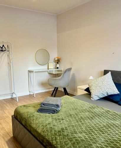 a bedroom with a bed and a chair and a desk at Bytom Syrah in Bytom
