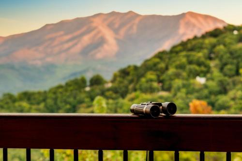 a camera sitting on a balcony with a mountain at Splashtacular: Indoor Pool~Gorgeous Views~HotTub~GameRoom~Resort in Gatlinburg
