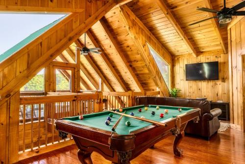 a living room with a pool table in a cabin at Splashtacular: Indoor Pool~Gorgeous Views~HotTub~GameRoom~Resort in Gatlinburg