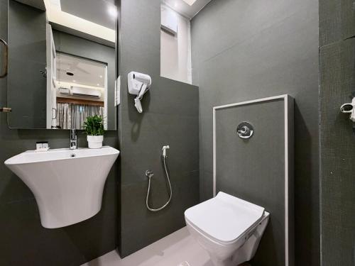 a small bathroom with a toilet and a sink at MILANO By The Beach Goa in Benaulim