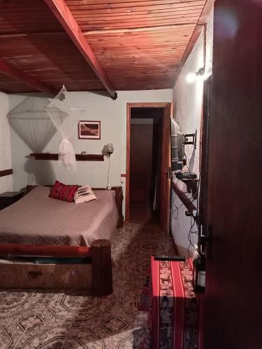 a bedroom with a bed and a door to a room at Lo de Fabi in La Coronilla