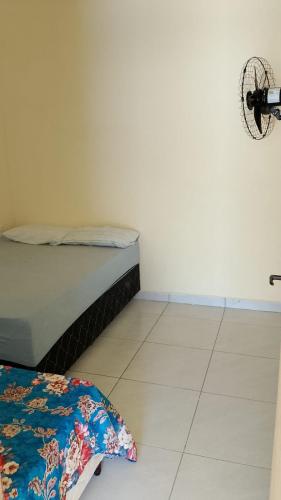 a bedroom with a bed and a tiled floor at Casa temporada aracaju sergipe in Aracaju