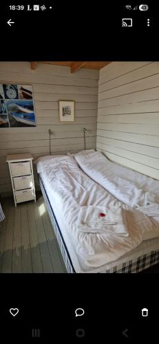 a large bed in a corner of a room at Lofotbo in Stamsund