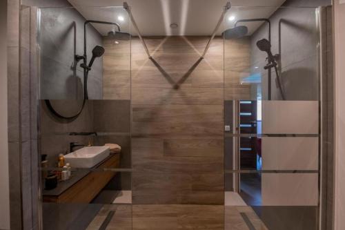 a bathroom with a shower with a sink and a mirror at Maison avec Spa Privatif, Jacuzzi et Sauna in Bailleval
