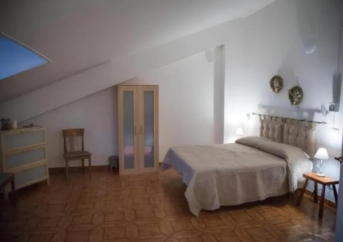 a white bedroom with a bed and a dresser at B&B SANTA MARIA VALLEVERDE appartamento vicinissimo alla Clinica L'immacolata in Celano