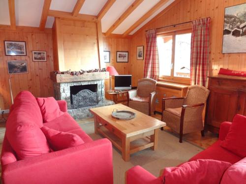 a living room with red furniture and a fireplace at Juliette in Verbier