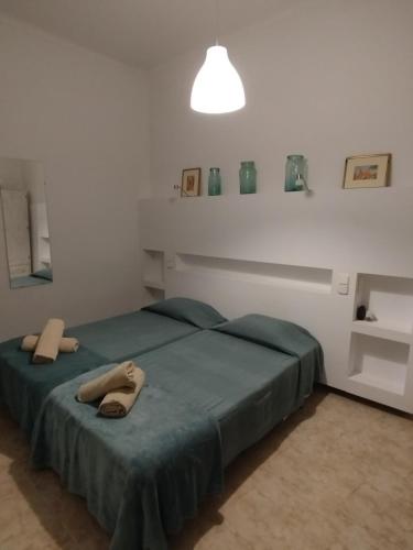 a bedroom with two beds with towels on them at ca sa tia in Santanyi