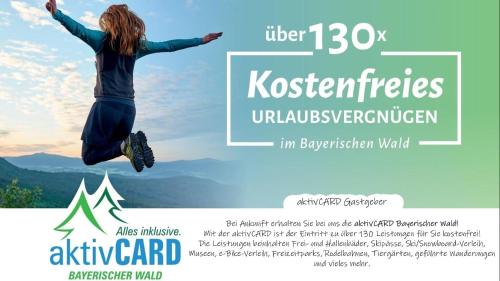 a woman jumping in the air with a mountain at Sylva Apartment in Sankt Englmar